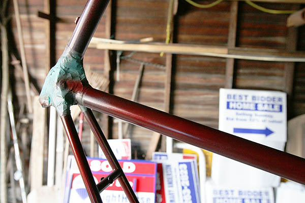 First thin coat of metallic red paint on bicycle frame